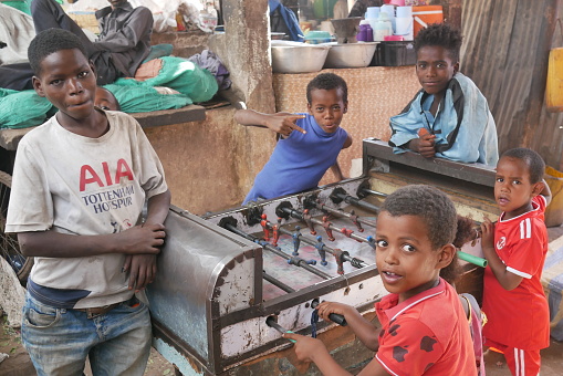 Dire Dawa, Ethiopia – 11.05.2022: children and teenagers play a game of table football inside the market