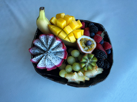 a bowl of a selection of tropical fruits