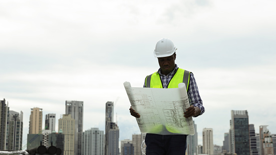 Condtruction Engineer Black Construction Engineer Holding Blueprint Working At Construction ...