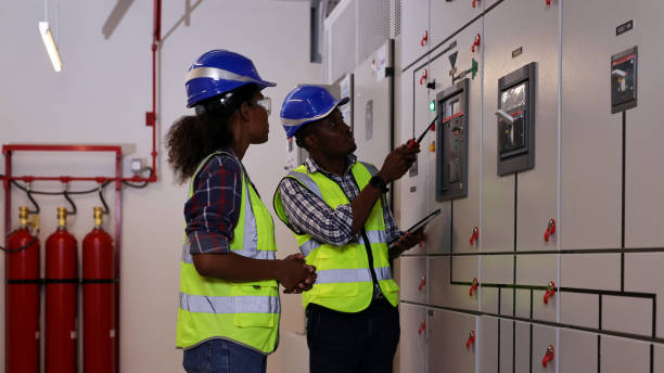 istock Male and Female electrical engineer team working in control room, Electrical power supply for factory industrial concept 1488685577