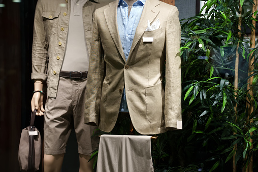 Men's summer clothes in a shop window.