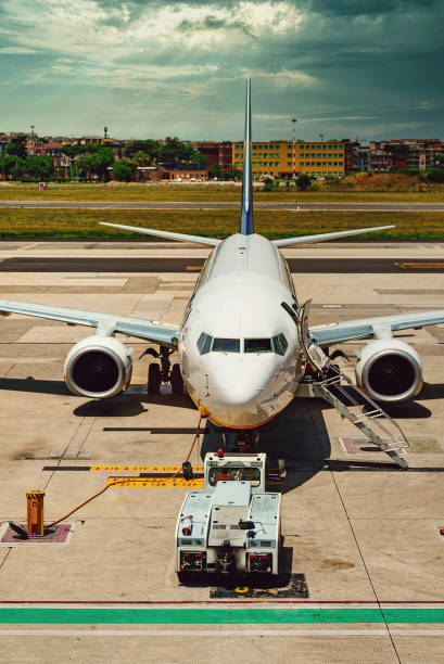 istock TUG Pushback tractor with Aircraft on the runway in airport. 1488686833