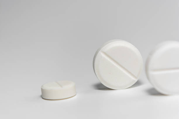 istock White pills close-up on a light background. 1488689545