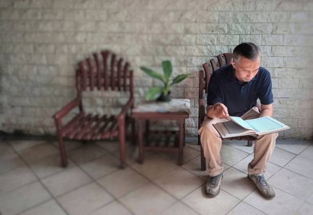 istock Asian is reading a book in a casual outfit. 1488691608