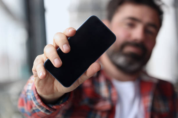 istock Bearded Man Showing Mobile Phone 1488691644