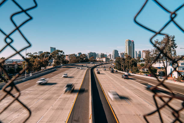 Artistic Long Shutter Photo Looking Through a Chain Link Fence at Early Afternoon Interstate 5 Traffic in San Diego, California near Petco Park