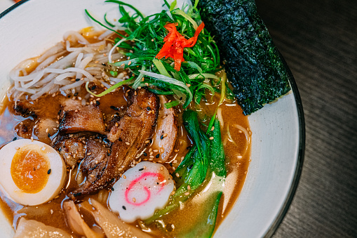 Tonkotsu Pork Broth with Pork Belly, Noodles, Soft-Boiled Egg, Green Onions, Marinated Bamboo Shoots, Bean Sprouts, Pickled Ginger, Bok Choy, Naruto, and Nori.