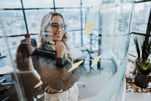 business woman brainstorming behind the window glass - business seminar writing women imagens e fotografias de stock