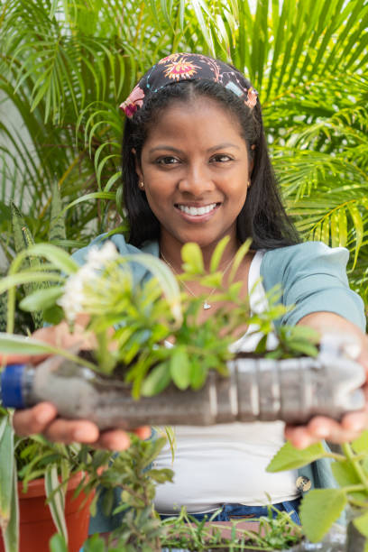 istock woman holding a flower pot 1488696080