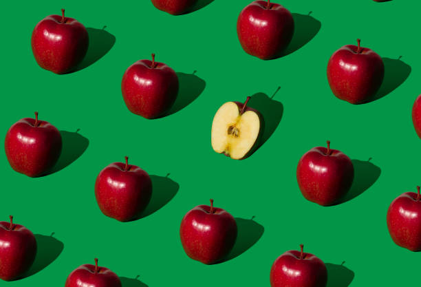 istock Be different. Trendy fruit pattern made of red apples on bold green background. Nature creative concept. Minimal layout. 1488696111