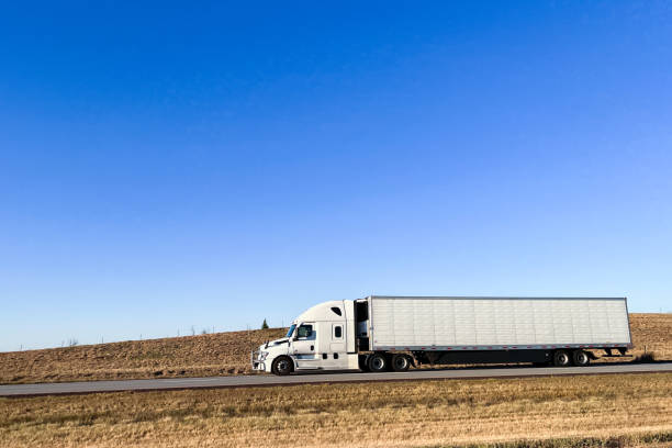 istock Driver's Perspective of a Conventional Cab-Forward Semi Truck on Interstate 70 Driving West across Kansas on a Sunny Day 1488696189