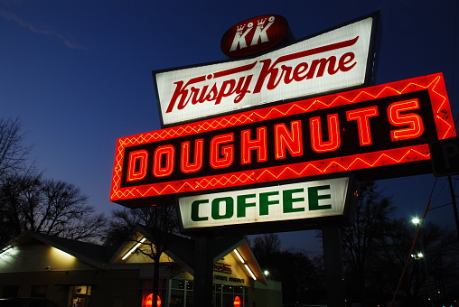 Raleigh, NC, USA March 14 An illuminated neon sign glows in front of the Krispy Krene Doughnuts, a popular donut shop in Raleigh, North Carolina