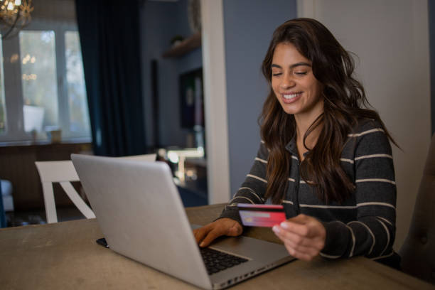 istock Cheerful  woman doing online shopping 1488699947