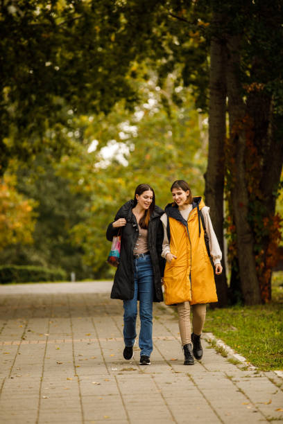 istock Two young women taking a relaxing walk through the park, chatting casually and bonding 1488700135