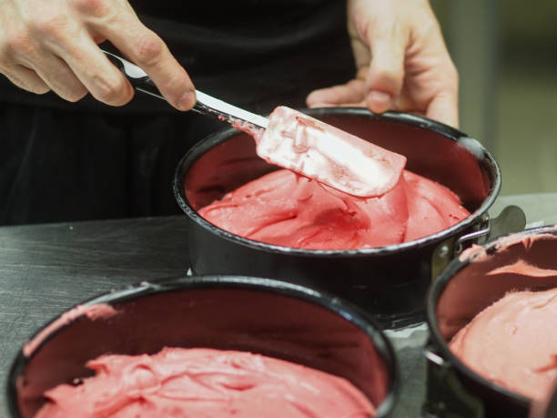 istock chef preparing white pink red cakes to bake in the oven 1488701046