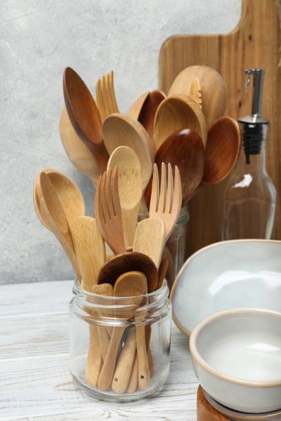 istock Different kitchenware and dishware on white wooden table against textured wall 1488704610