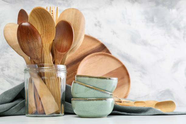 istock Different dishware and utensils on white marble table against textured wall 1488704618