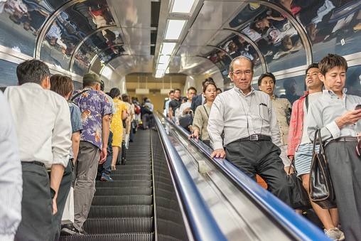 Tokyo, Japan - July 14, 2016: Middle aged business man commutes via Tokyo subway system.