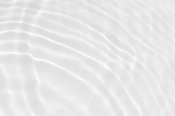 istock White water with ripples on the surface. Defocus blurred transparent white colored clear calm water surface texture with splashes and bubbles. Water waves with shining pattern texture background. 1488707599