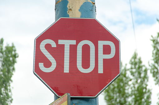 Stop sign on an old pole.