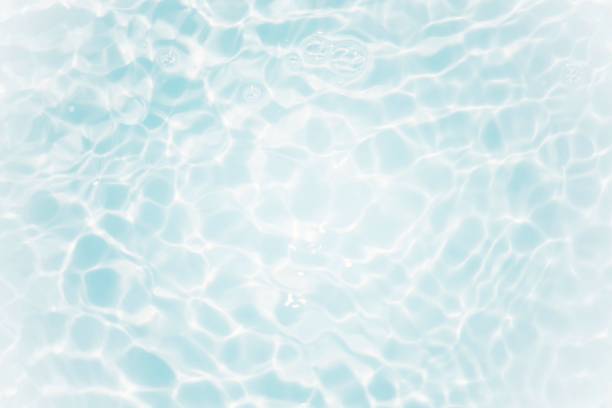 istock Blue water with ripples on the surface. Defocus blurred transparent blue colored clear calm water surface texture with splashes and bubbles. Water waves with shining pattern texture background. 1488710825