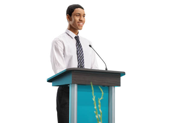 istock Young african american man standing behind a podium and smiling 1488713529