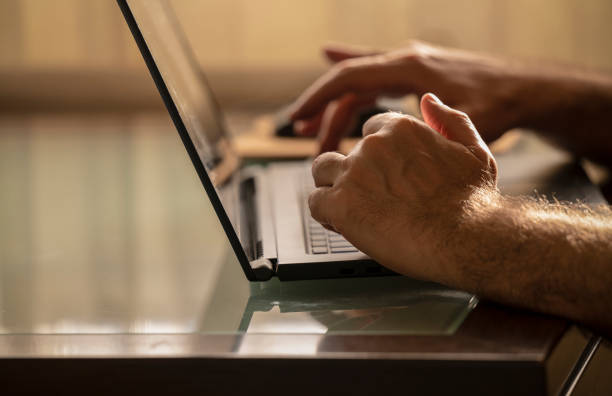 istock Closeup of hands using laptop at home 1488716547