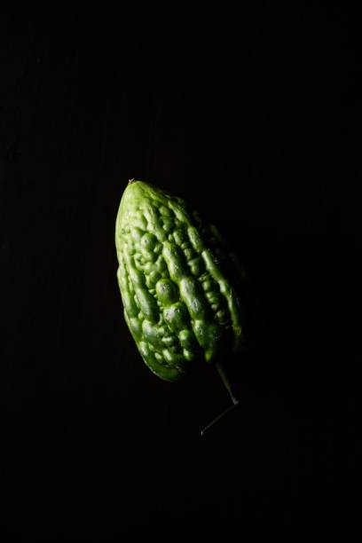 Fresh bitter gourd (Momordica Charantia) isolated on black background stock photo