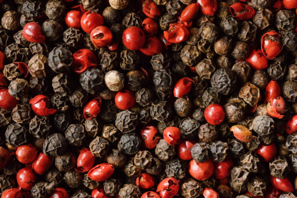 Black and red peppercorns close up stock photo