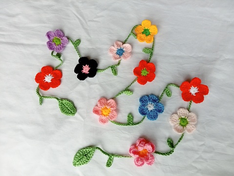 Crochet necklace floral multicoloured flowers pattern handmade background texture