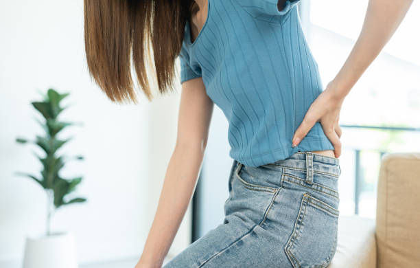 istock Asian woman has problem with structural posture She had back pain at sofa. She massage her shoulders for relief. reduce muscle tension. 1488730053