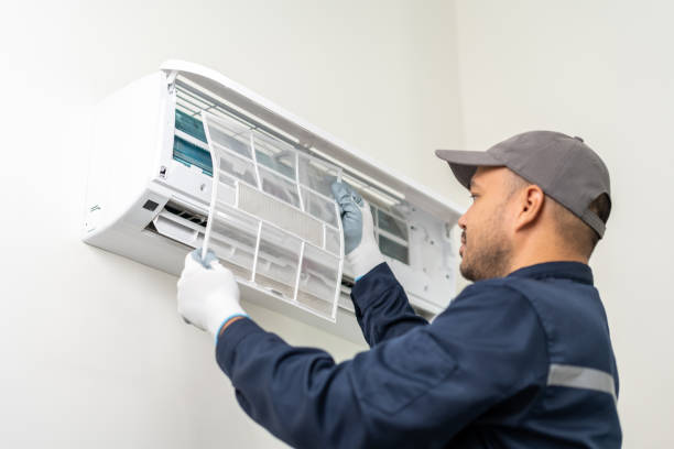 istock Air conditioner service indoors. Air conditioner cleaning technician He opened the front cover and took out the filters and washed it. He in uniform wearing rubber 1488730862