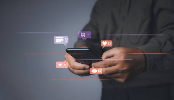 istock Man using mobile phone shopping online with social media notification icons. 1488732164
