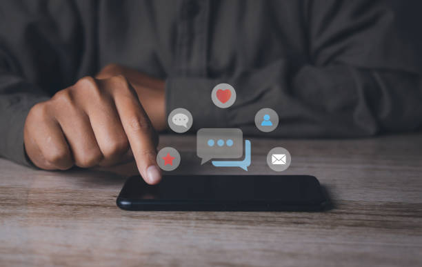 istock man using smartphone with social media to interactions icon on internet post. 1488732170