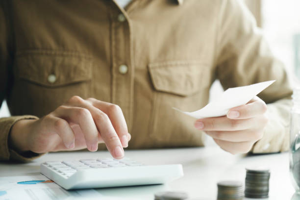 istock Accountant using calculator for calculate finance report in office 1488733617