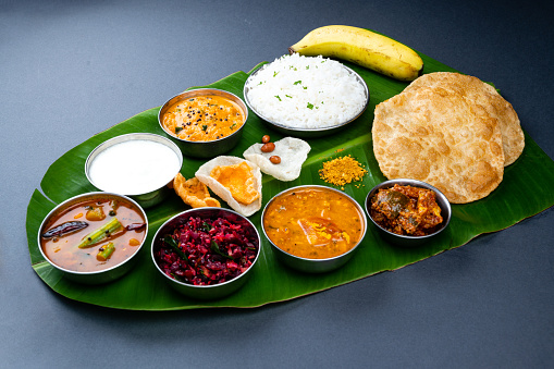 South Indian Veg Thali / food platter\nAge South Indian thali is a sight to behold! delicious and nutritious meal with a variety of flavours and textures, all served on a traditional banana leaf.