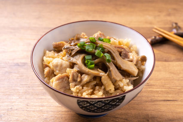 Rice cooked with maitake mushrooms stock photo