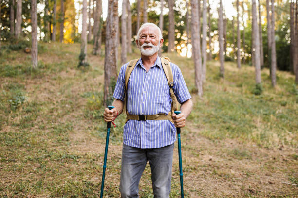 istock Senior man using hiking poles on a hike 1488748776
