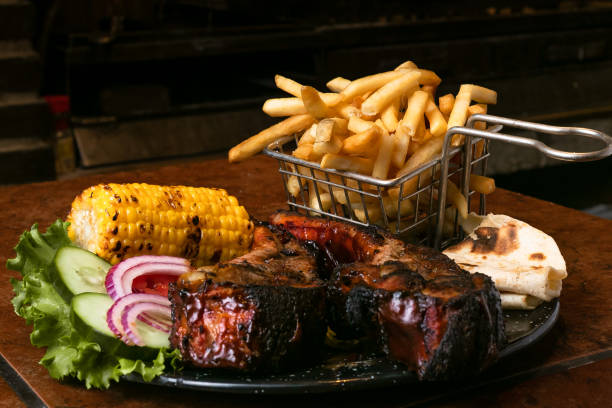 istock beef steak grilled, vegetables, fries and grilled corn on a dish into a rustic mexican restaurant 1488749095