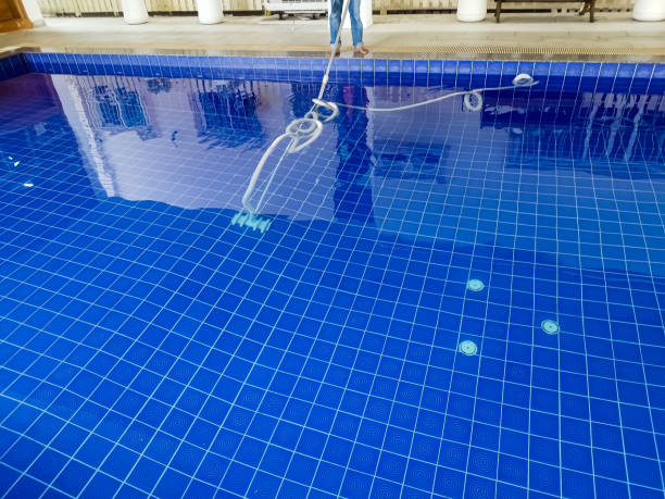 istock An image shows a pool cleaner using a kit used to connect to a suction hose when cleaning a domestic pool. 1488752838