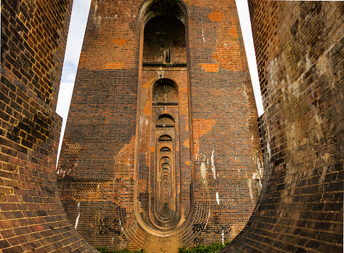 The diminishing perspective of the red brick arches beneath the Ouse Valley Viaduct in West Sussex,  England.