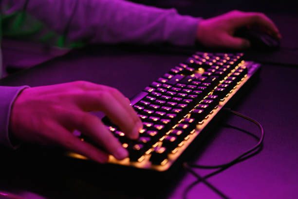 istock Close-up of a hand on a keyboard in neon color. Selective focus 1488761654