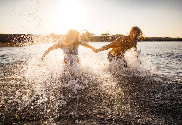 istock Young playful couple having fun in the sea. 1488763496