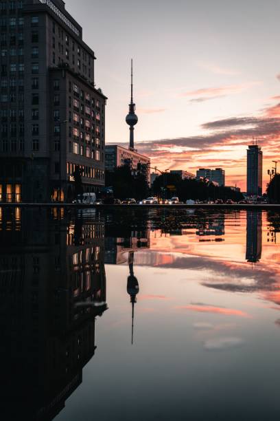 Berlin, Germany – August 03, 2022: The Berlin TV Tower and other buildings reflected in the water during sunset
