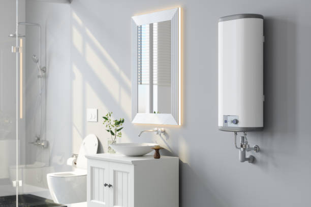 vista de primer plano del calentador de agua, espejo y gabinete blanco en el baño moderno - heat sink fotografías e imágenes de stock
