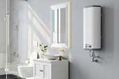 Close-up View Of Water Heater, Mirror And White Cabinet In Modern Bathroom