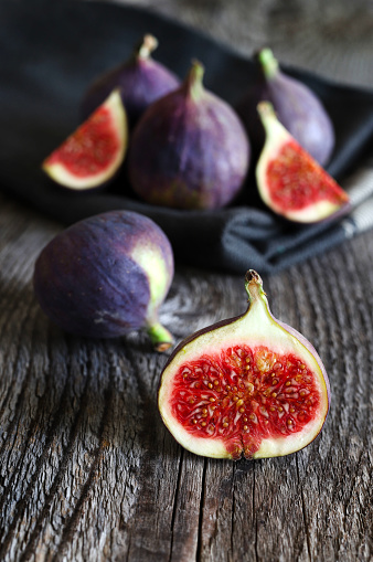 Group of fresh figs isolated isolated on wooden table. Overhead view. Copy space.
