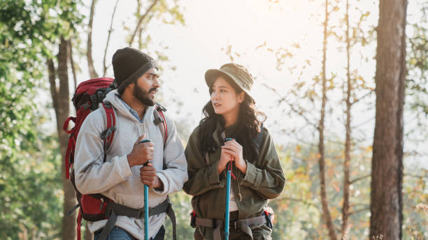 istock Travelers hiking with backpack traveling in forest wild and look around and explore while walking in nature wood. happy holiday vacation trip. 1488771413
