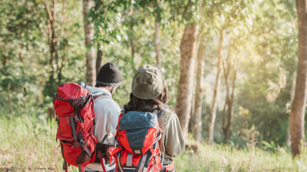 istock Travelers hiking with backpack traveling in forest wild and look around and explore while walking in nature wood. happy holiday vacation trip. 1488771481