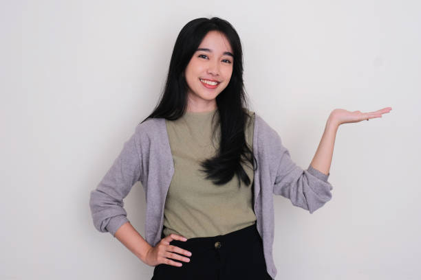 istock Asian young woman smiling with her left hand facing up holding something 1488771601